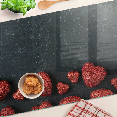 Tagliere in vetro temperato con motivo a cuori rossi su sfondo scuro