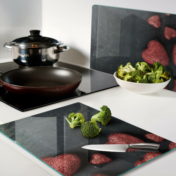 Tagliere in vetro temperato con motivo a cuori rossi su sfondo scuro