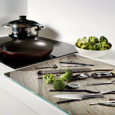 Tagliere in vetro con motivo di strumenti per parrucchieri su sfondo di legno