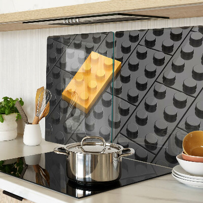 Tagliere in vetro con stampa di mattoncini LEGO su sfondo nero