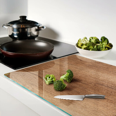 Tagliere in vetro con motivo a venature di legno che riflette la luce della finestra