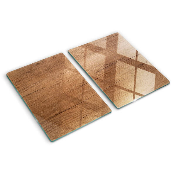 Tagliere in vetro con motivo a venature di legno che riflette la luce della finestra