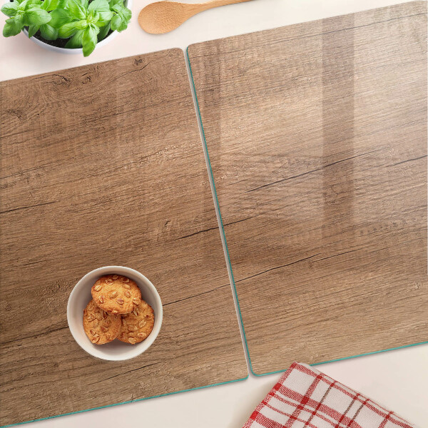 Tagliere in vetro con motivo a venature di legno che riflette la luce della finestra