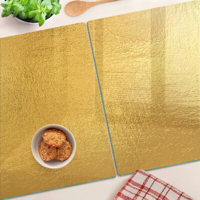 Tagliere in vetro temperato con superficie dorata dai riflessi luminosi