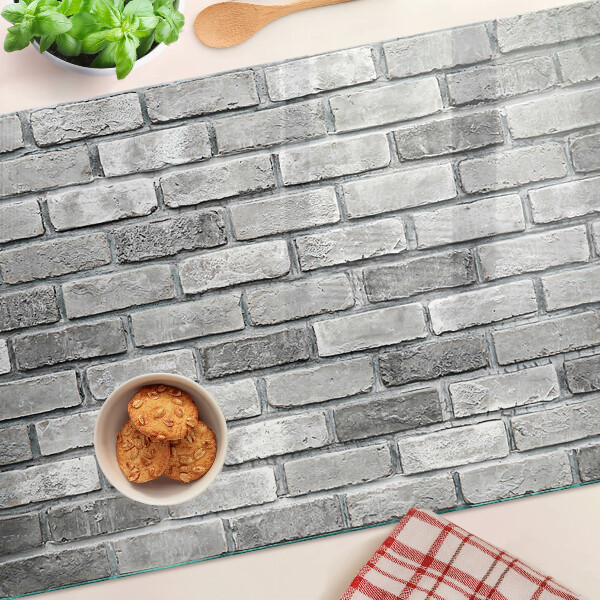 Tagliere in vetro temperato con motivo a muro di mattoni nei toni del grigio