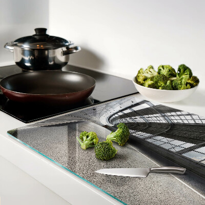 Tagliere in vetro temperato con motivo di architettura moderna e geometrie decorative