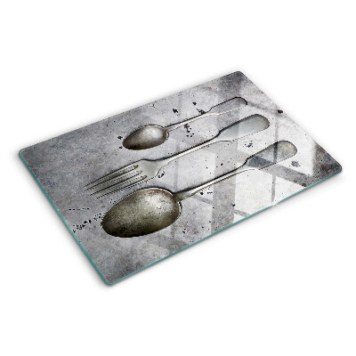 Tagliere in vetro temperato con motivo di posate su sfondo effetto cemento