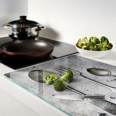 Tagliere in vetro temperato con motivo di posate su sfondo effetto cemento