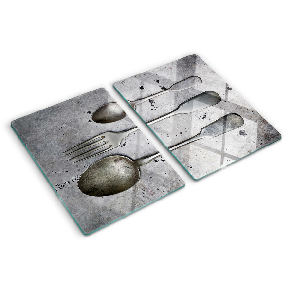 Tagliere in vetro temperato con motivo di posate su sfondo effetto cemento