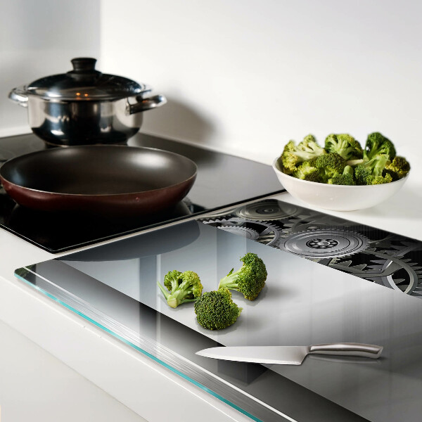 Tagliere in vetro con motivo di ingranaggi meccanici e superfici metalliche