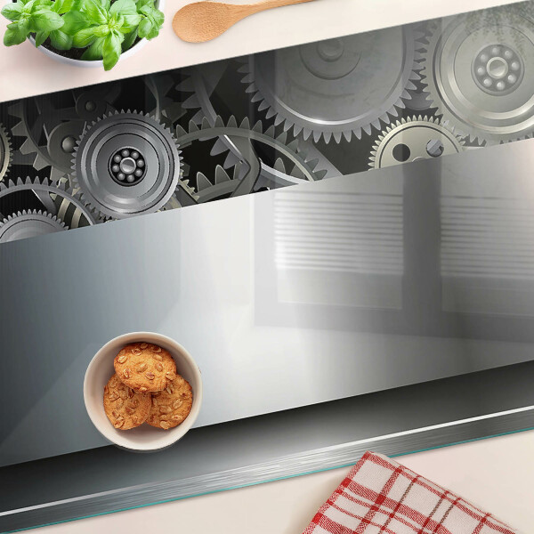 Tagliere in vetro con motivo di ingranaggi meccanici e superfici metalliche