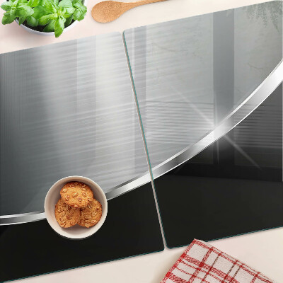 Tagliere in vetro con finitura metallica e riflessi decorativi