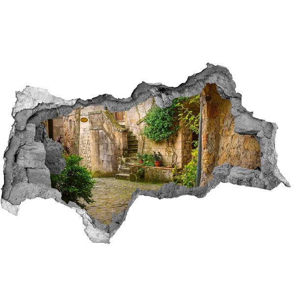 Adesivo con vista dietro il muro Un grazioso cortile nel centro storico