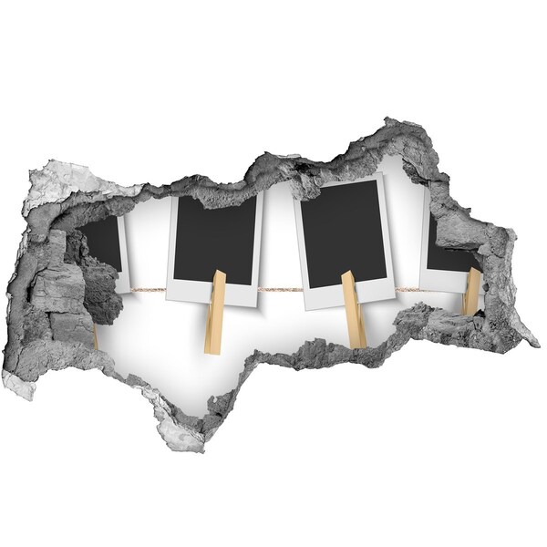 Decorazione da parete buco nel muro Un muro danneggiato con cornici per quadri.