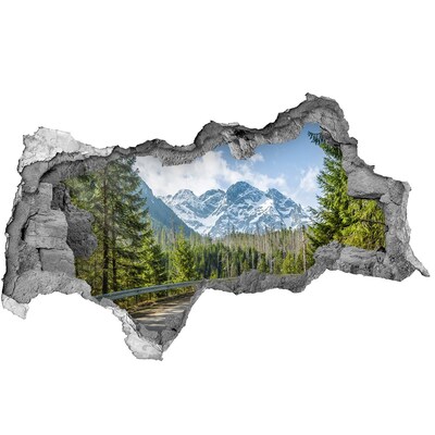 Sticker effetto rottura muro Paesaggio montano dietro il buco nel muro