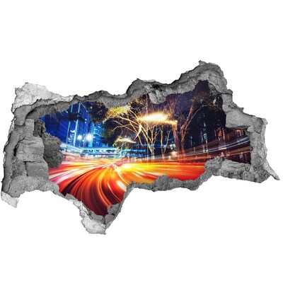 Adesivo con vista dietro il muro Una città in movimento di notte