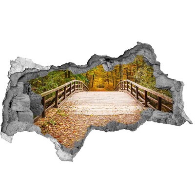 Sticker effetto rottura muro Un ponte nella foresta autunnale