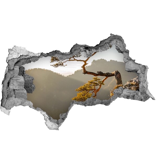 Adesivo con vista dietro il muro Paesaggio montano con un albero