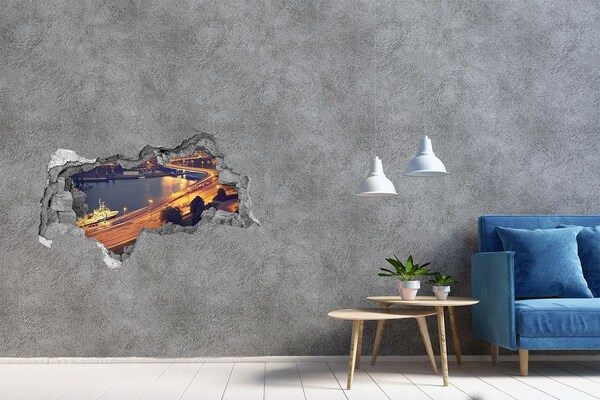 Adesivo con vista dietro il muro Veduta notturna della città