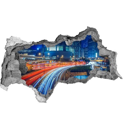 Adesivo con vista dietro il muro Città moderna di notte