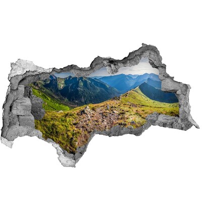 Sticker effetto rottura muro Paesaggio montano visto attraverso un buco nel muro