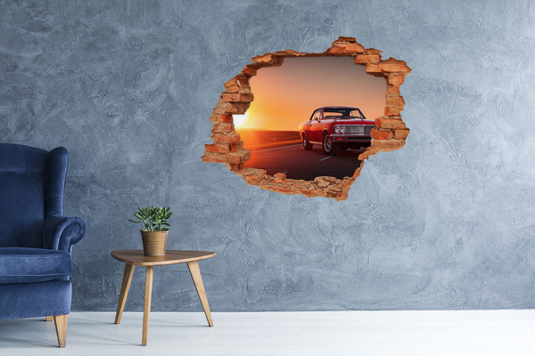 Adesivo murale buco 3D Auto d'epoca sullo sfondo di un tramonto