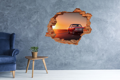 Adesivo murale buco 3D Auto d'epoca sullo sfondo di un tramonto