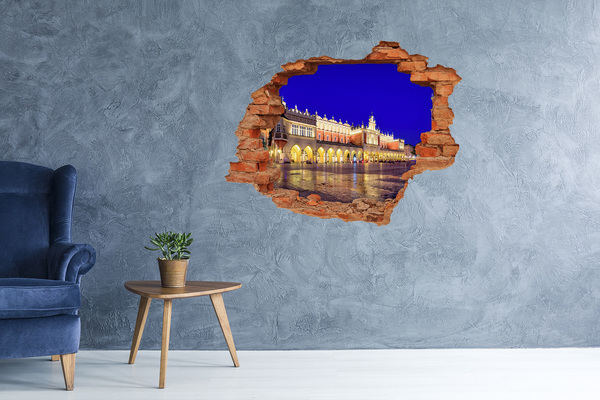 Adesivo effetto buco nel muro La piazza del mercato principale di Cracovia di notte