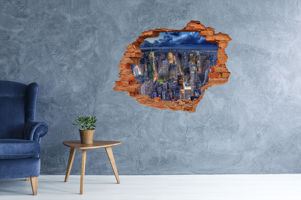 Adesivo effetto buco nel muro Lo skyline di New York di notte