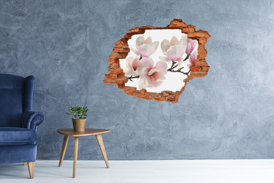 Adesivo con buco sbrecciato Fiori di magnolia sbocciano attraverso un buco nel muro