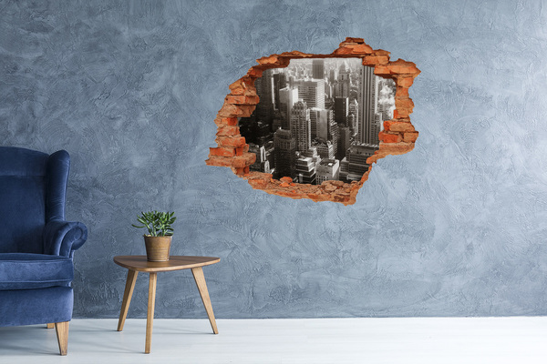 Adesivo con buco sbrecciato Vista della città da un buco nel muro