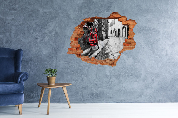 Adesivo con buco sbrecciato Una bicicletta rossa in una strada affascinante