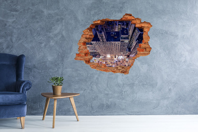 Adesivo effetto buco nel muro Vista notturna della città dall'alto.