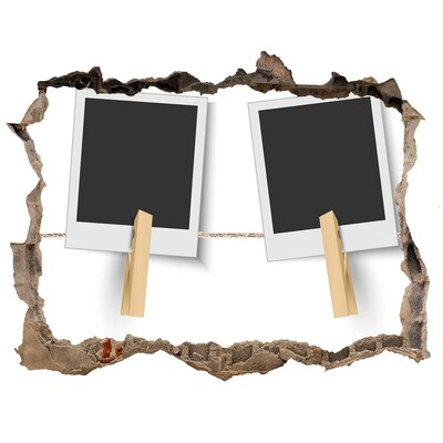 Adesivo buco nel muro Un muro danneggiato con cornici per quadri.