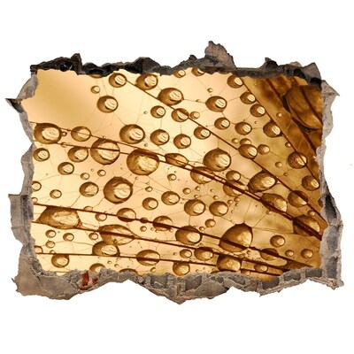 Adesivo buco nel muro Una goccia dorata sullo sfondo di cemento