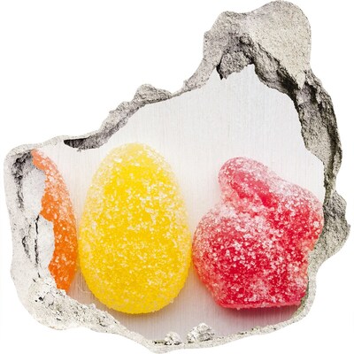 Trompe l'oeil buco nel muro Caramelle gommose dolci in un buco nel muro