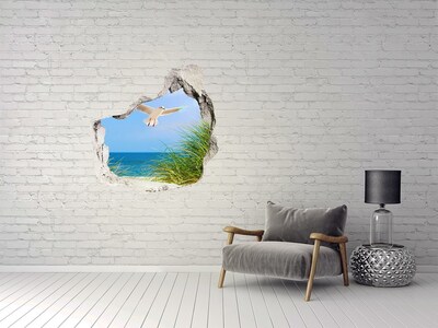 Trompe l'oeil buco nel muro Vista della spiaggia con un gabbiano