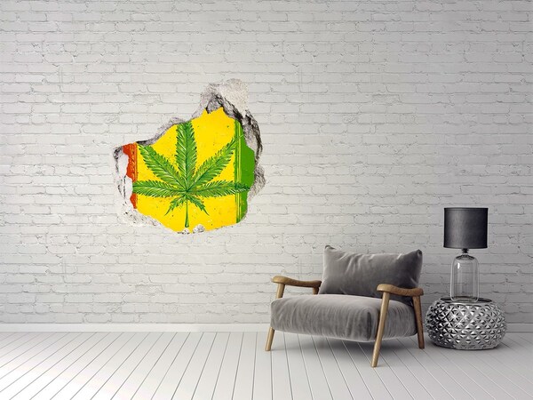 Trompe l'oeil buco nel muro Foglia di cannabis verde su sfondo giallo-rosso-verde