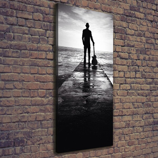 Quadro foto su tela verticale Chitarrista sul molo