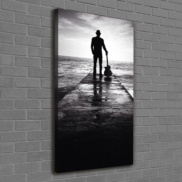 Quadro foto su tela verticale Chitarrista sul molo