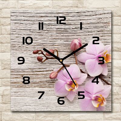 Orologio quadrato con motivo di orchidea su sfondo effetto legno