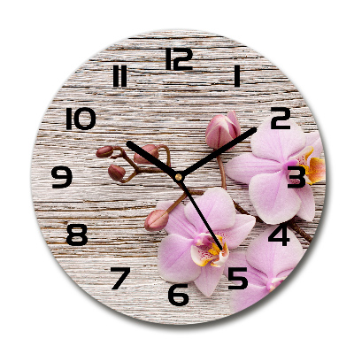 Orologio rotondo in vetro con motivo di orchidea su sfondo effetto legno