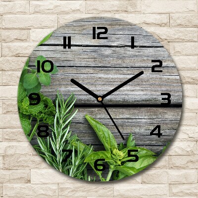 Orologio rotondo con motivo di erbe aromatiche su sfondo in legno