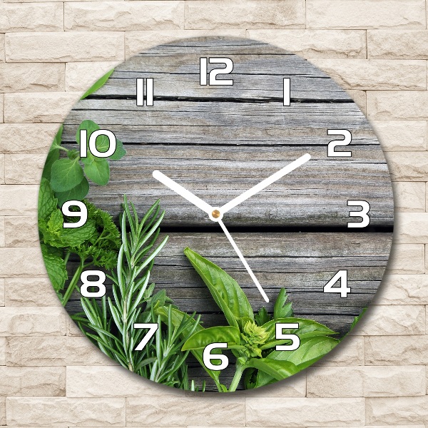 Orologio rotondo con motivo di erbe aromatiche su sfondo in legno