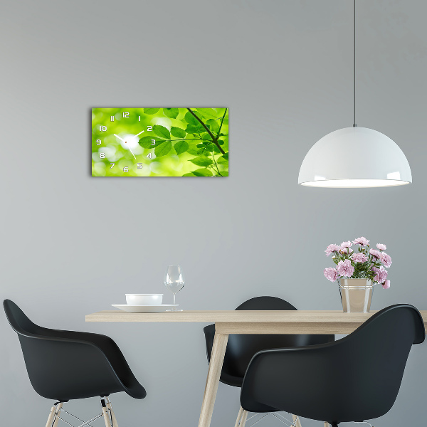 Orologio rettangolare con quadrante decorato da foglie verdi