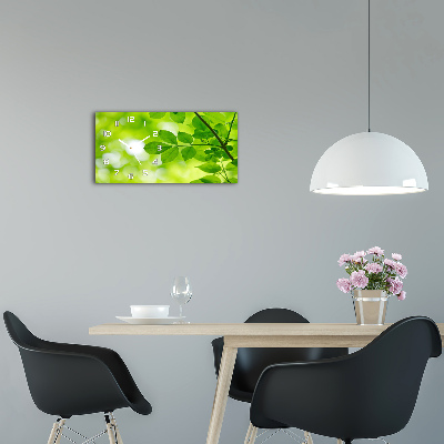 Orologio rettangolare con quadrante decorato da foglie verdi