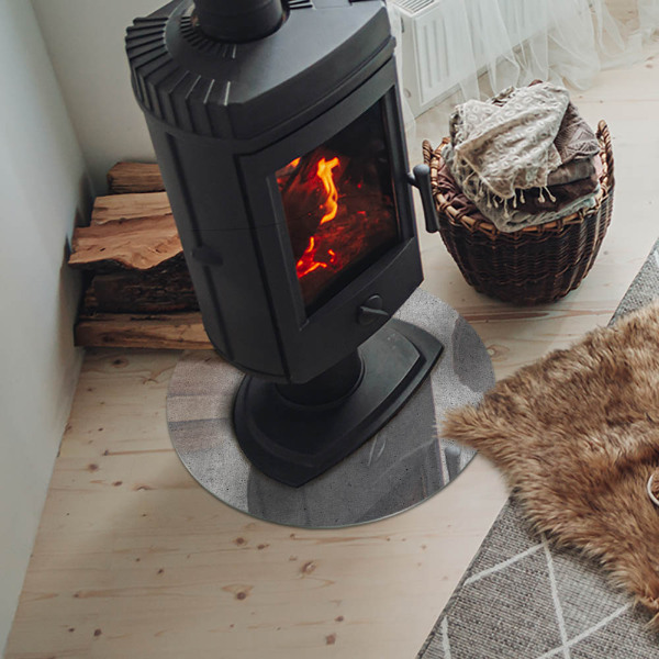 Vetro sotto il camino rotondo con struttura in calcestruzzo grezzo