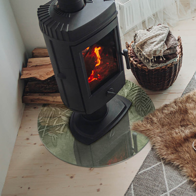 Vetro sotto il camino rotondo con motivo di foglie tropicali sullo sfondo