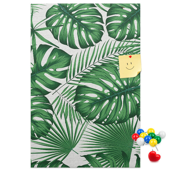 Bacheca di sughero con stampa di foglie di Monstera su sfondo chiaro