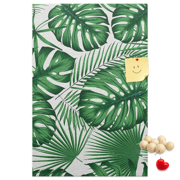 Bacheca di sughero con stampa di foglie di Monstera su sfondo chiaro